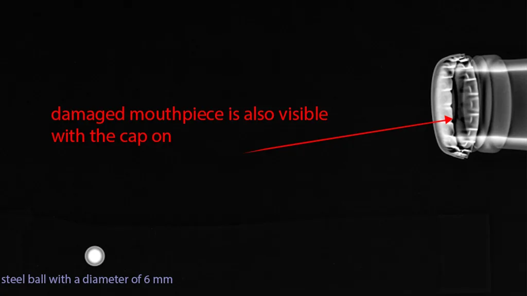 X-ray image of a damaged bottle mouthpiece, visible with the cap on