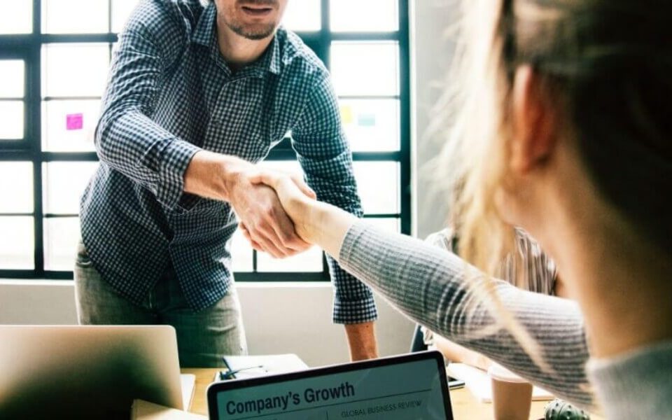 man and woman shaking hands